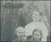 (Butler family near a felled tree)